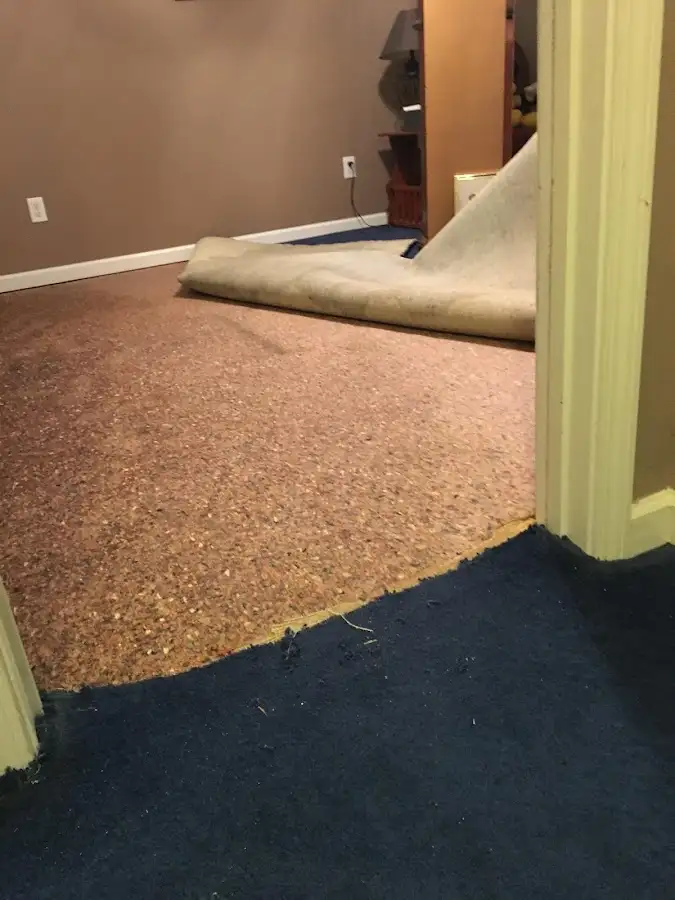 Carpet pad removal revealing water damage during Drying & Dehumidification in Spencer