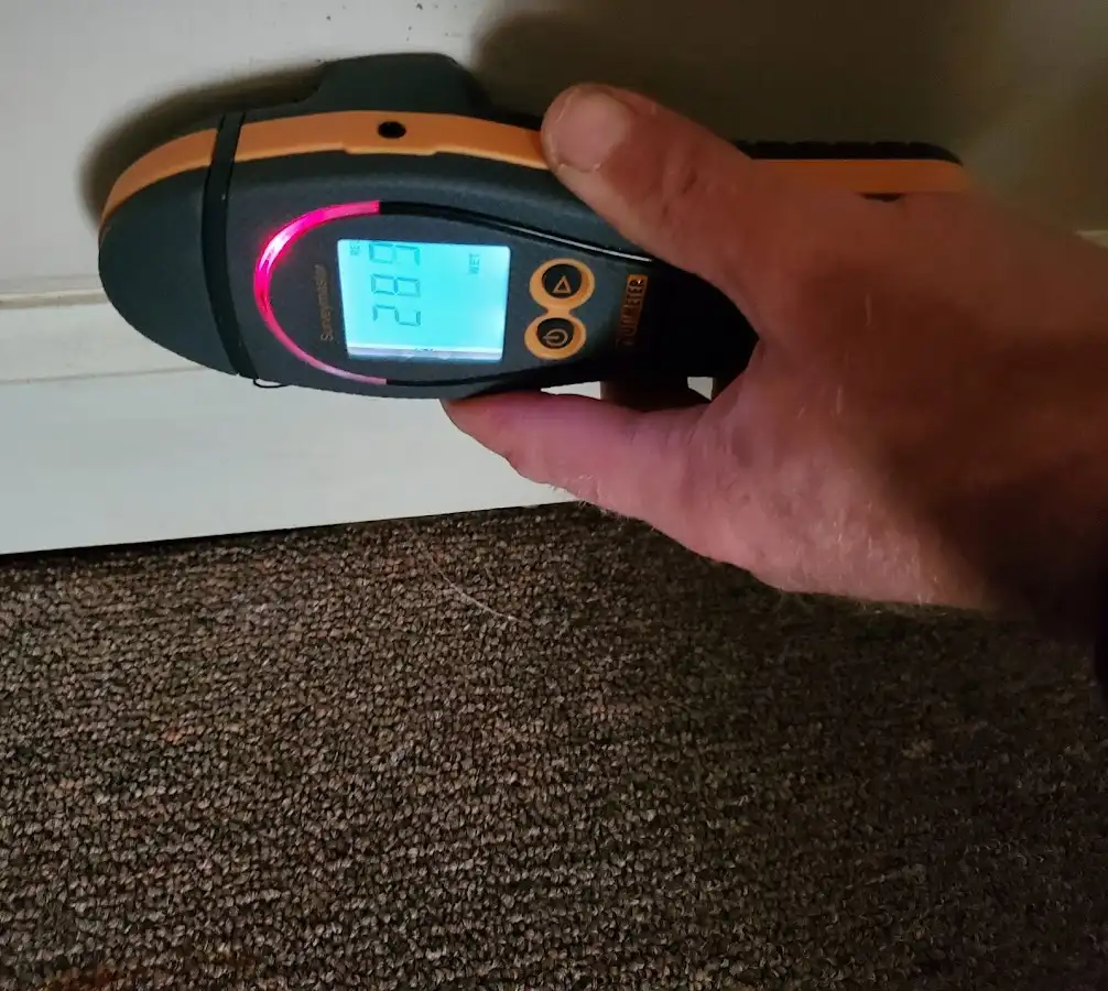 Moisture detection at baseboard during Storm Damage Restoration in Spencer